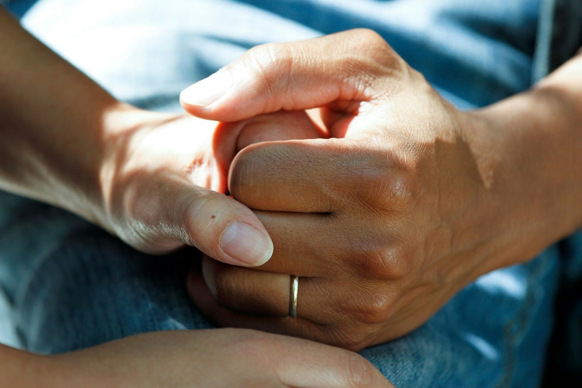 patient holding hand with doctor